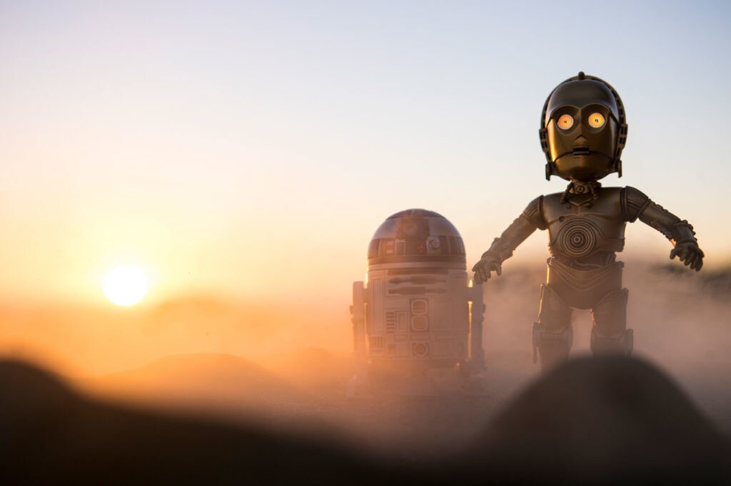 Toy versions of R2-D2 and C-3PO cross a desert landscape in an illusory image created by toy photographer Johnny Wu.