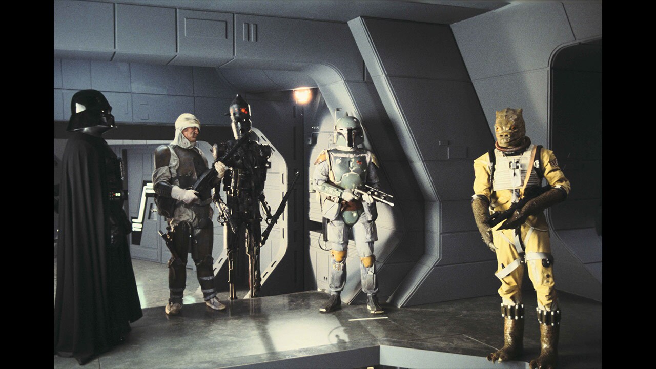 Darth Vader talks to a group of bounty hunters onboard a Superstar Destroyer.