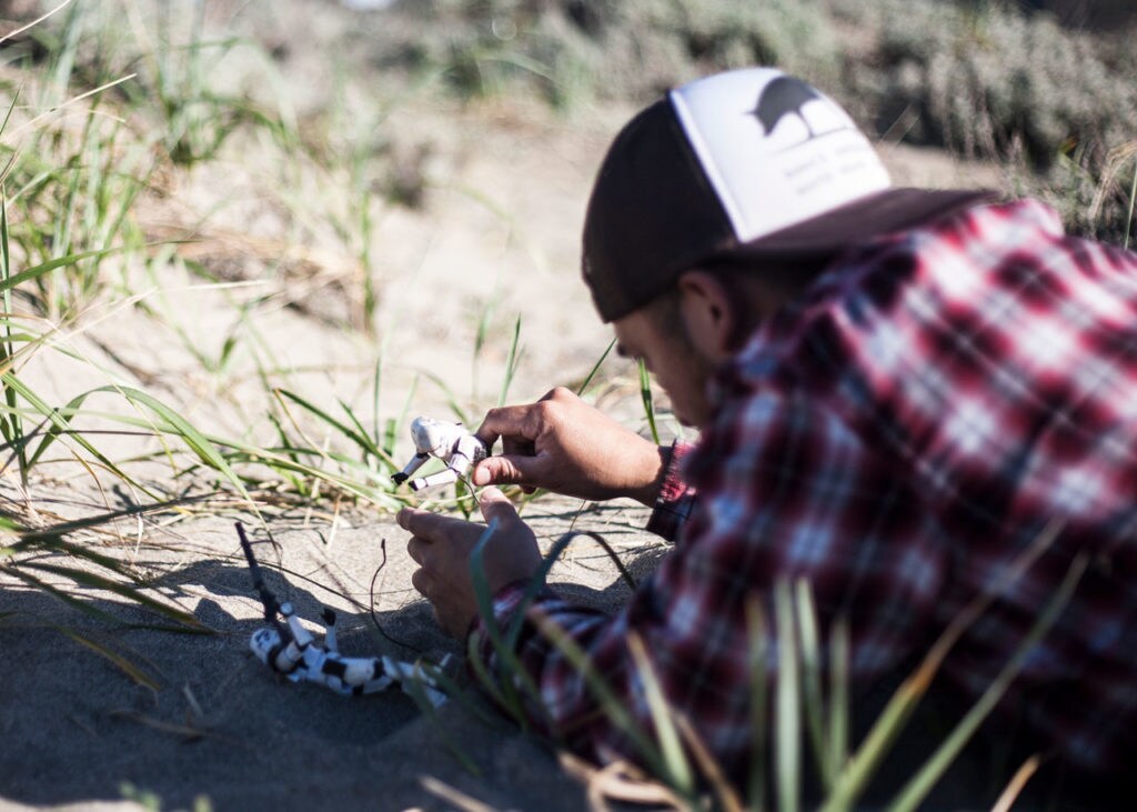 Johnny Wu poses stormtrooper action figures in the dirt.