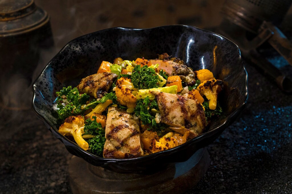The Oven-roasted Tip Yip, found at Docking Bay 7 Food and Cargo inside Star Wars: Galaxy’s Edge, features roasted chicken with mixed greens, roasted vegetables, quinoa and pumpkin seeds with a creamy green curry ranch dressing. (David Roark/Disney Parks)