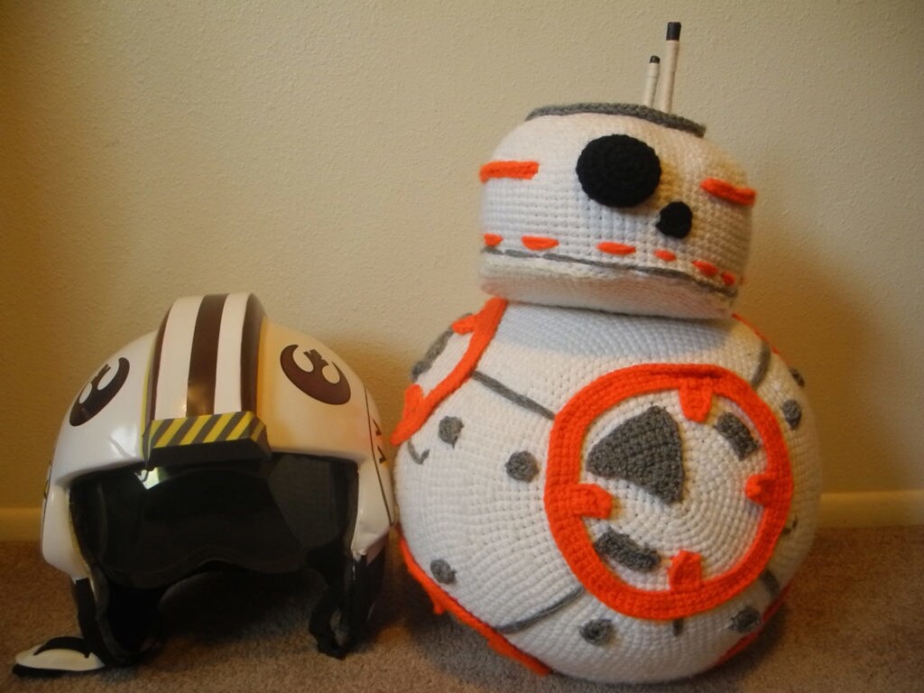 Ellie McPhee's crochet BB-8 sits next to a rebel helmet.