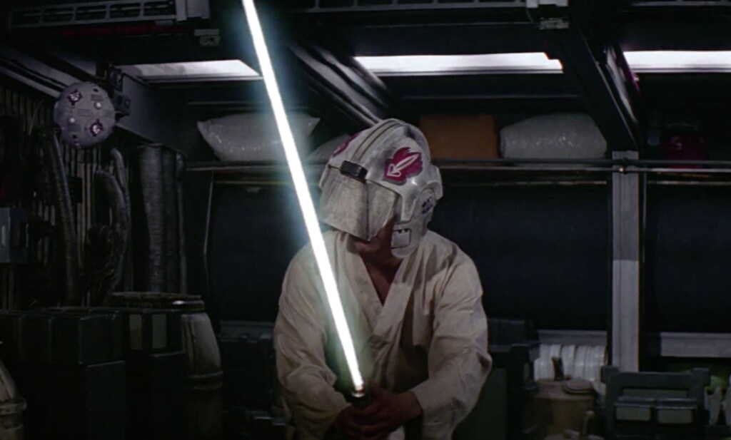 Luke trains with a lightsaber while wearing a blast shield helmet that blocks his sight in A New Hope.