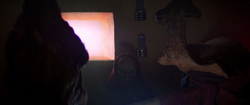 Aliens sit in the shadows of the Mos Eisley cantina.