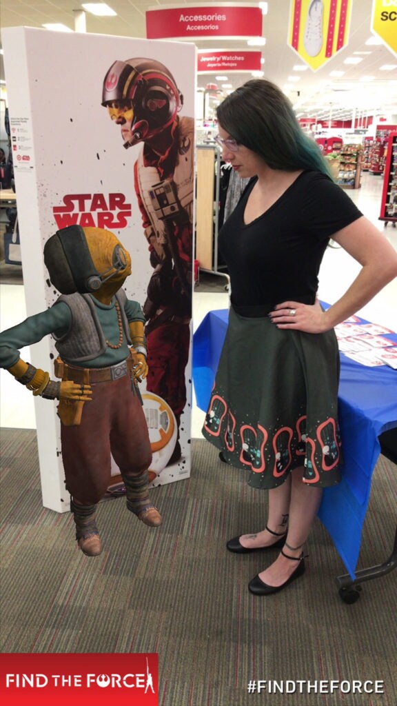 A computer generated Maz Kanata at Target from Find the Force, an augmented reality scavenger hunt game with game player Amy Ratcliffe.