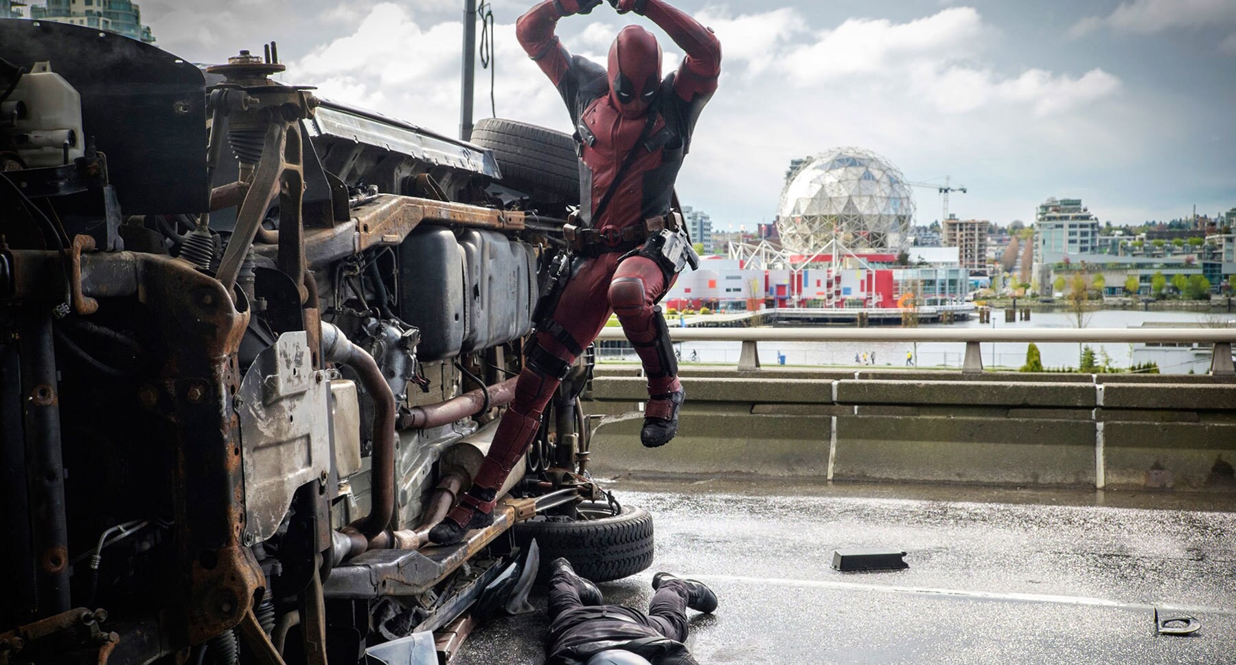 Ryan Reynolds (as Deadpool) jumping off a car in "Deadpool"