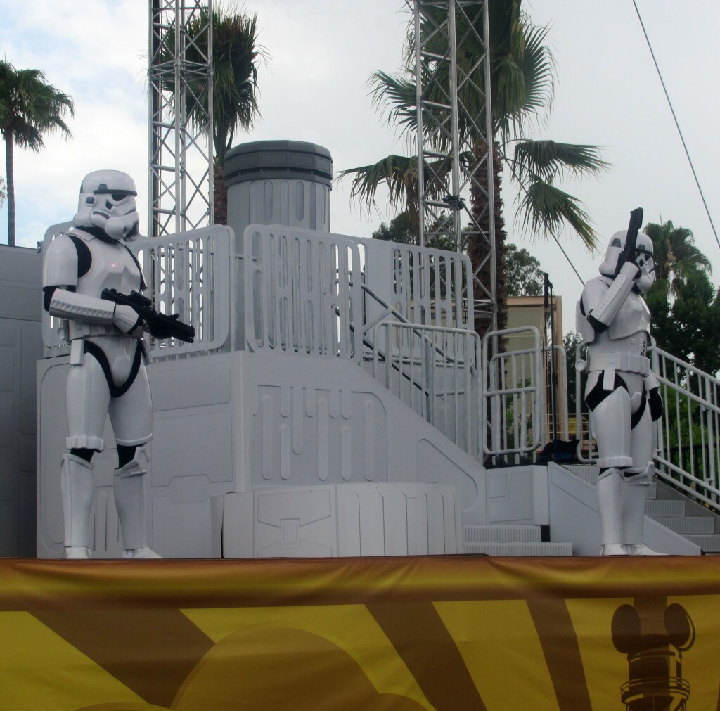 Two stormtroopers stand on stage at a Star Wars Weekend event.