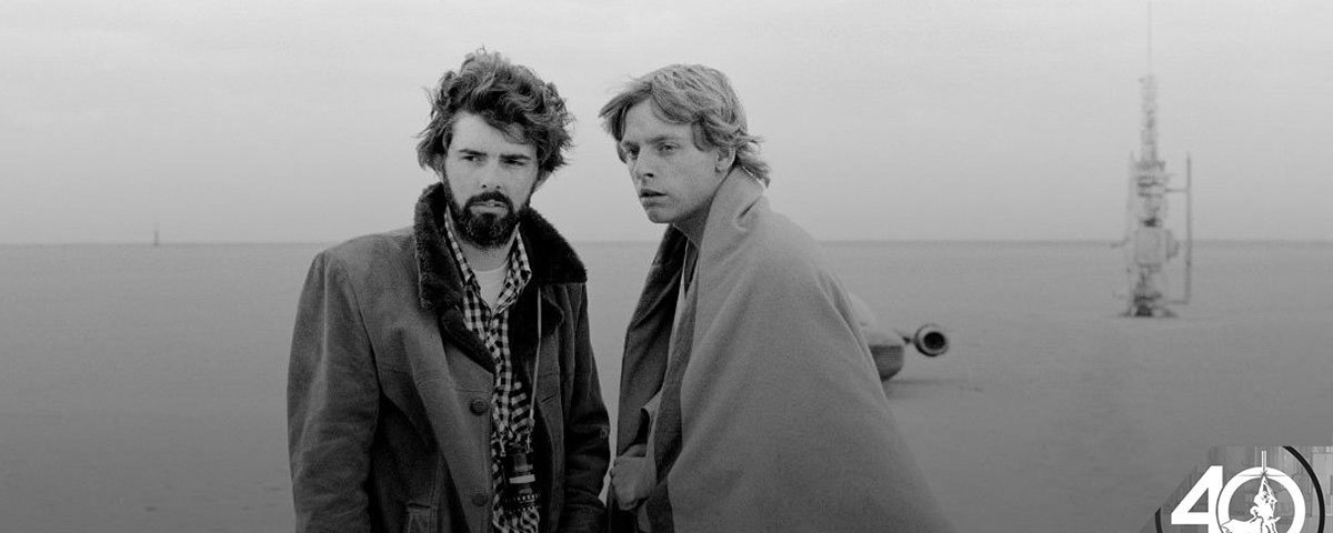 George Lucas and Mark Hamill stand together on the Tatooine set of A New Hope.