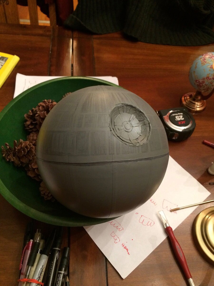 A Death Star globe in a bowl on a desk.
