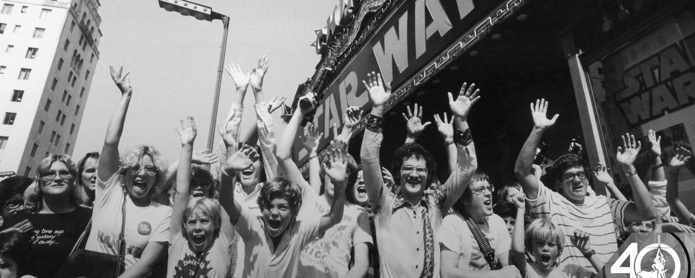 Excited fans throw their hands in the air outside Grauman's Chinese Theatre at the 1977 opening of Star Wars: A New Hope.