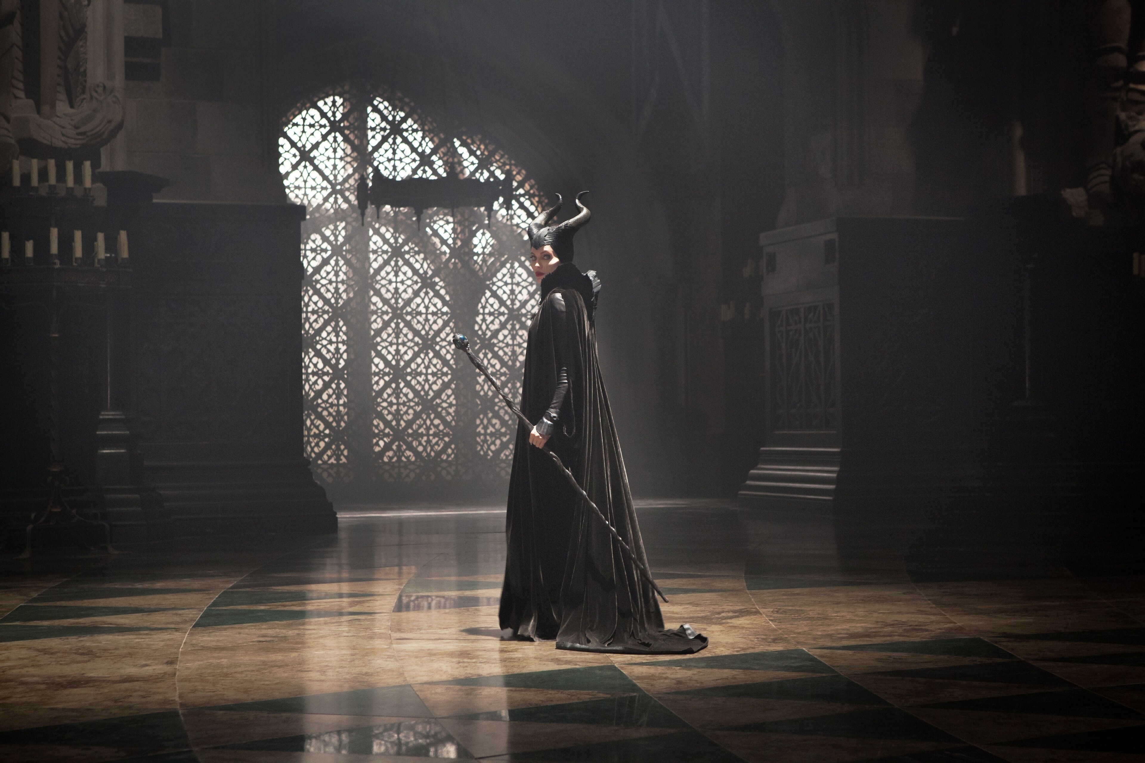 Angelina Jolie as Maleficent in room in the castle, looking back in the movie "Maleficent"