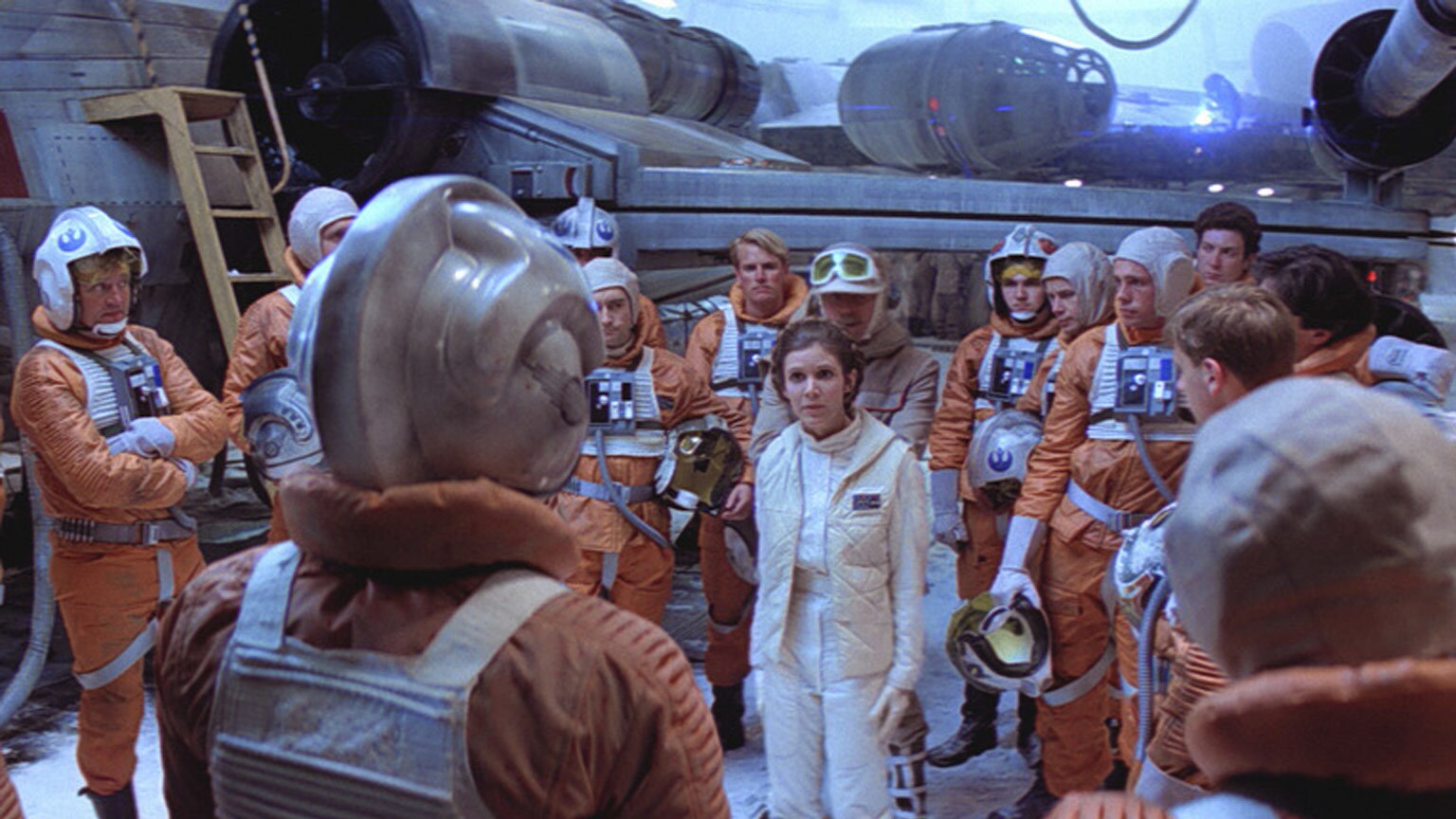 Princess Leia addresses a group of Rebel pilots who stand in a circle around her in The Empire Strikes Back.