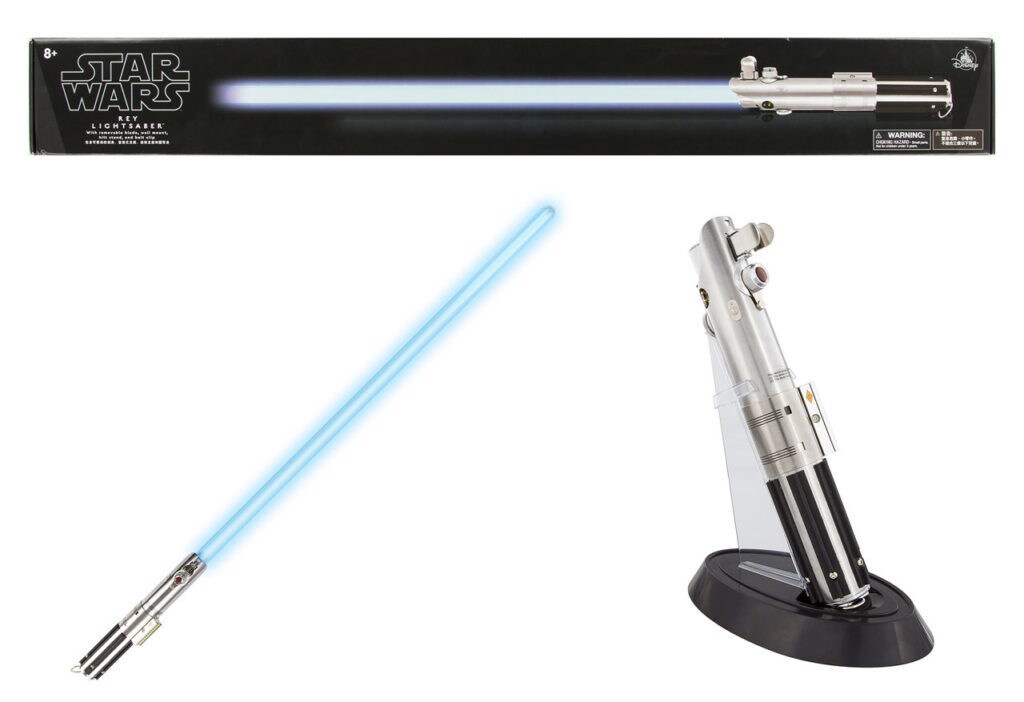 A blue toy lightsaber, along with a hilt stand and the box it comes in.