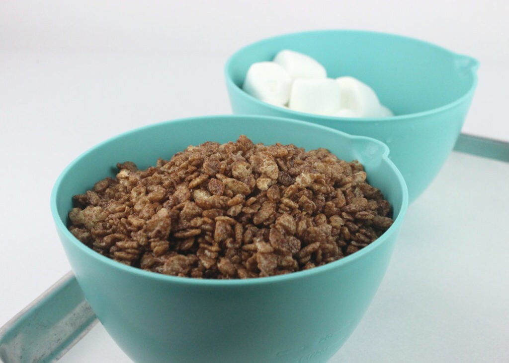 Bowls of chocolate rice cereal and marshmallows.