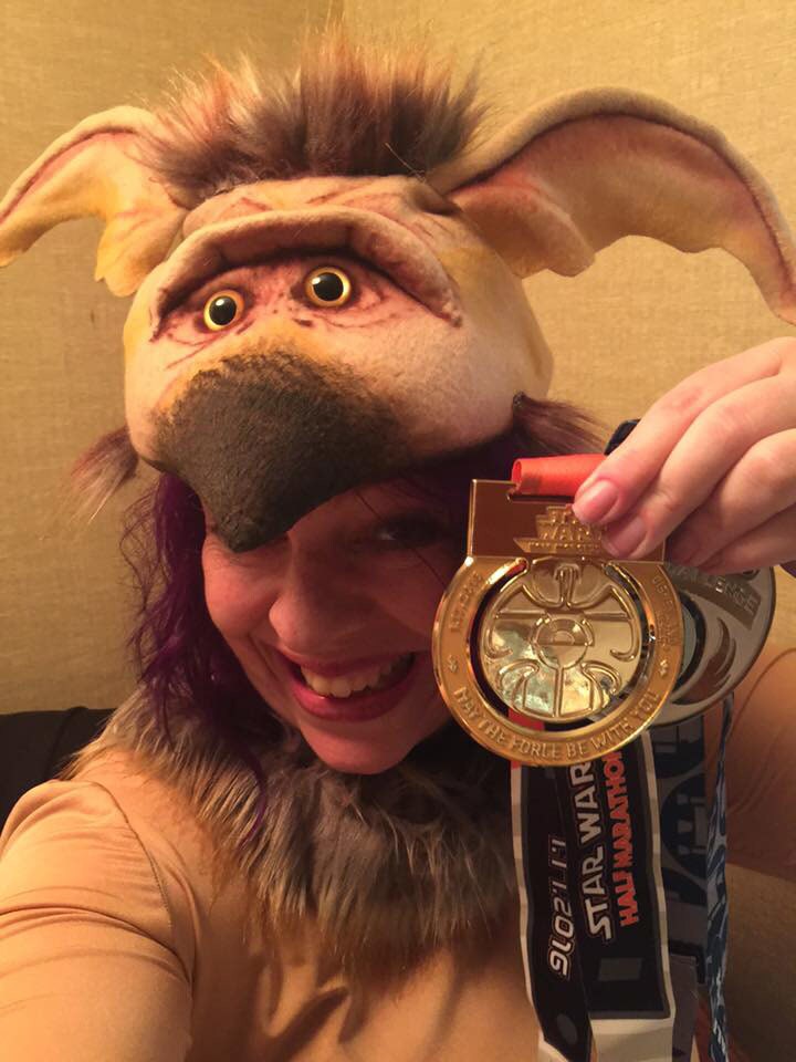 Fan Holly Frey shows off her Star Wars Half Marathon medal in Salacious B. Crumb costume.