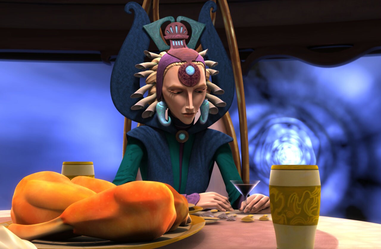 Satine Kryze sits at a table with a platter of deep-fried nuna legs while she looks at her drink.