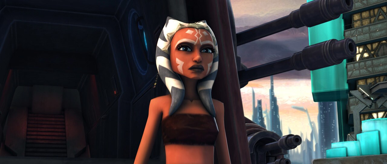 Ahsoka Tano stands in front of a large, armored vehicled in The Clone Wars.
