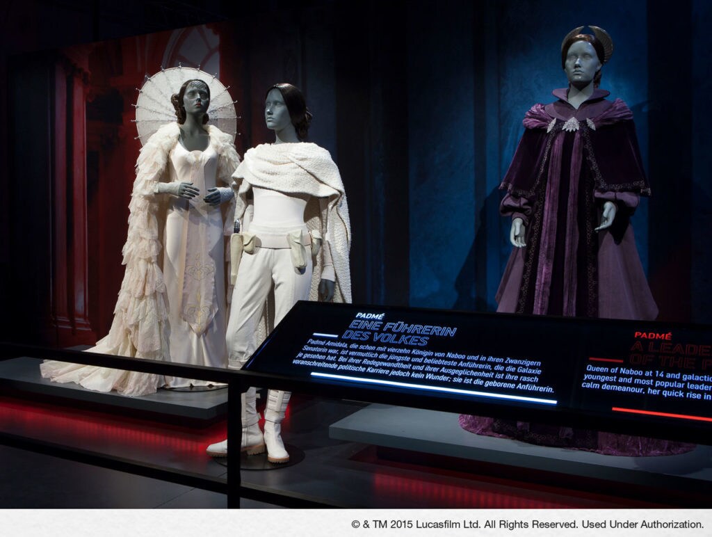 Several costumes worn by Padme Amidala on display at Star Wars Identities.