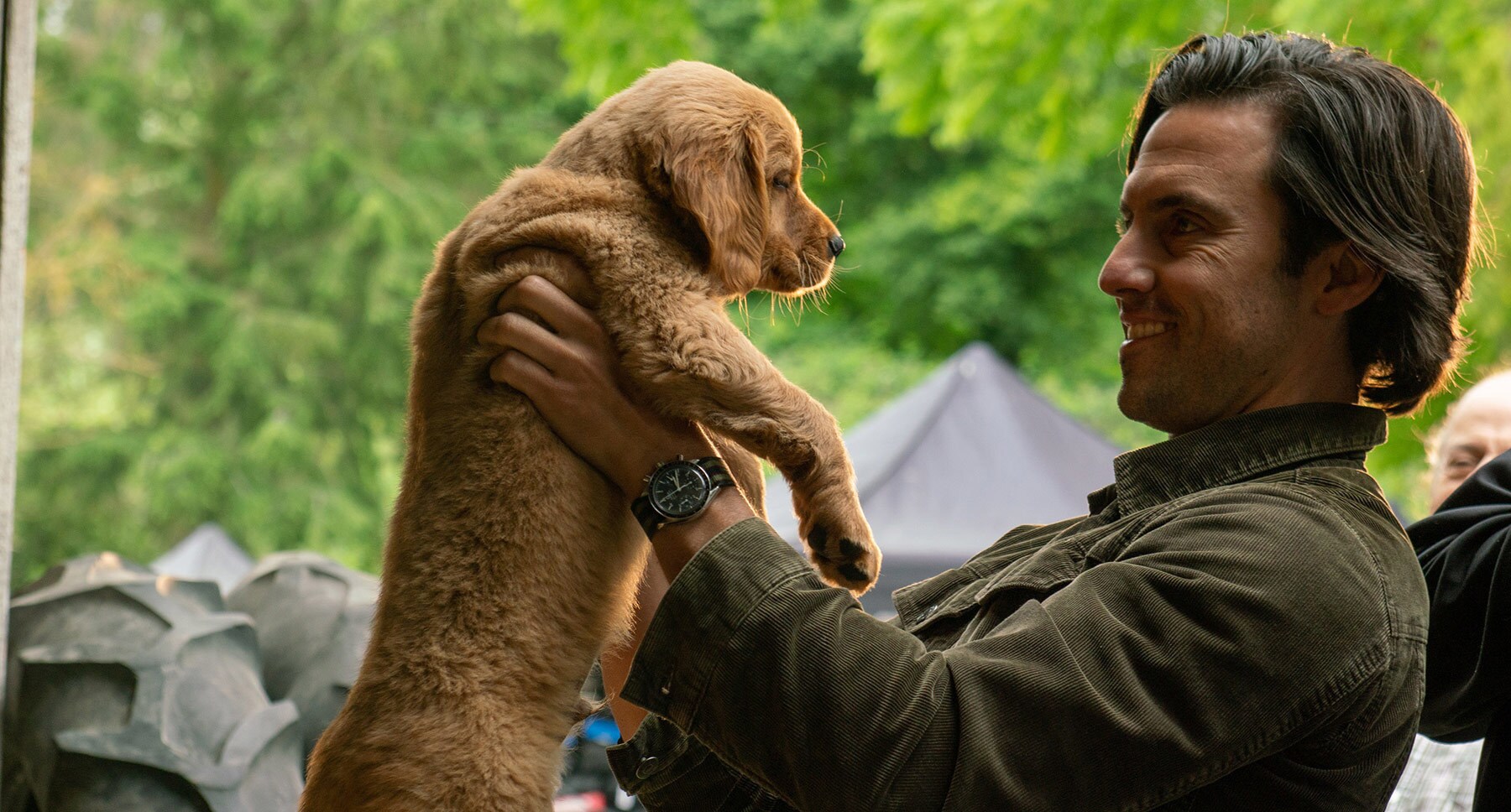 Denny (Milo Ventimiglia) and puppy Enzo in the movie "The Art of Racing in the Rain"