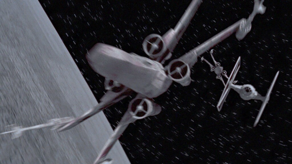 X-wing starfighters battle a TIE fighter around the Death Star.