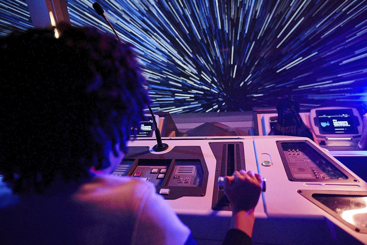 A child launches the Halcyon starcruiser to hyperspace from the Bridge in Star Wars: Galactic Starcruiser at Walt Disney World Resort in Lake Buena Vista, Fla. (Caitlyn McCabe, photographer)