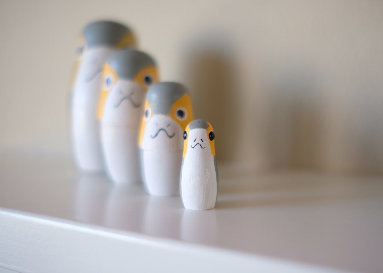A group of nesting dolls painted like porgs.