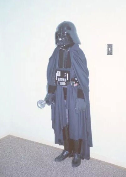 A Star Wars fan wears a Darth Vader costume.
