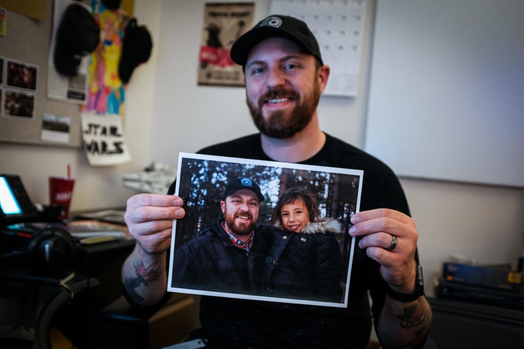 Chris Hawkinson of ILM holds a photo of himself and his daughter, his first Star Wars friend.