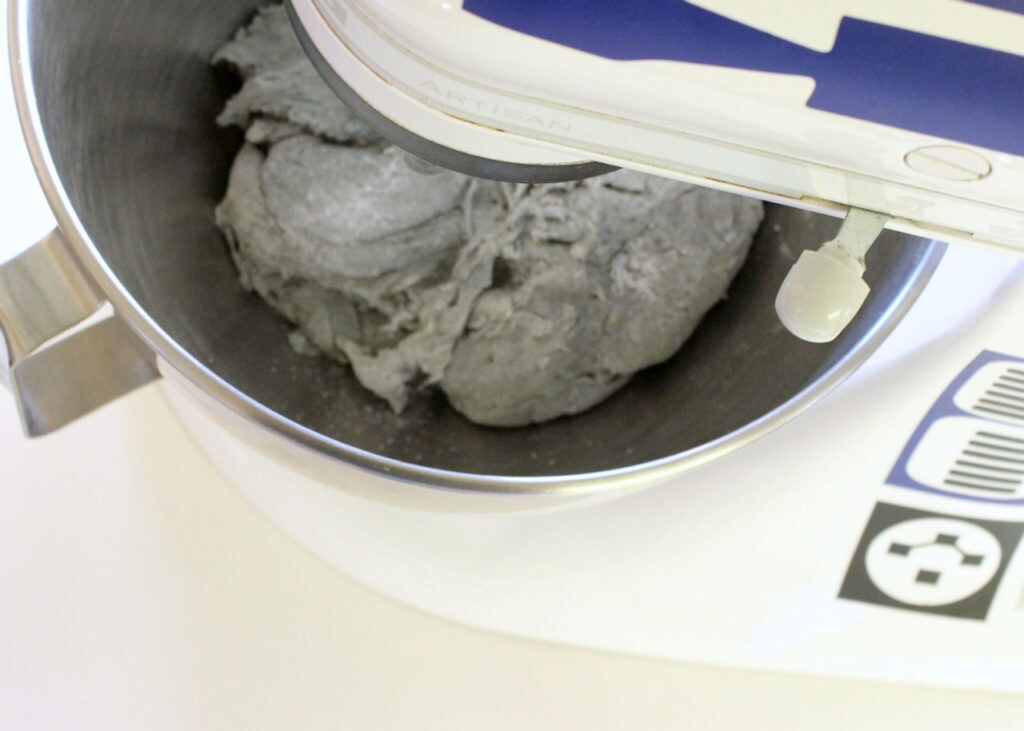 Grey dough in an electric mixer.