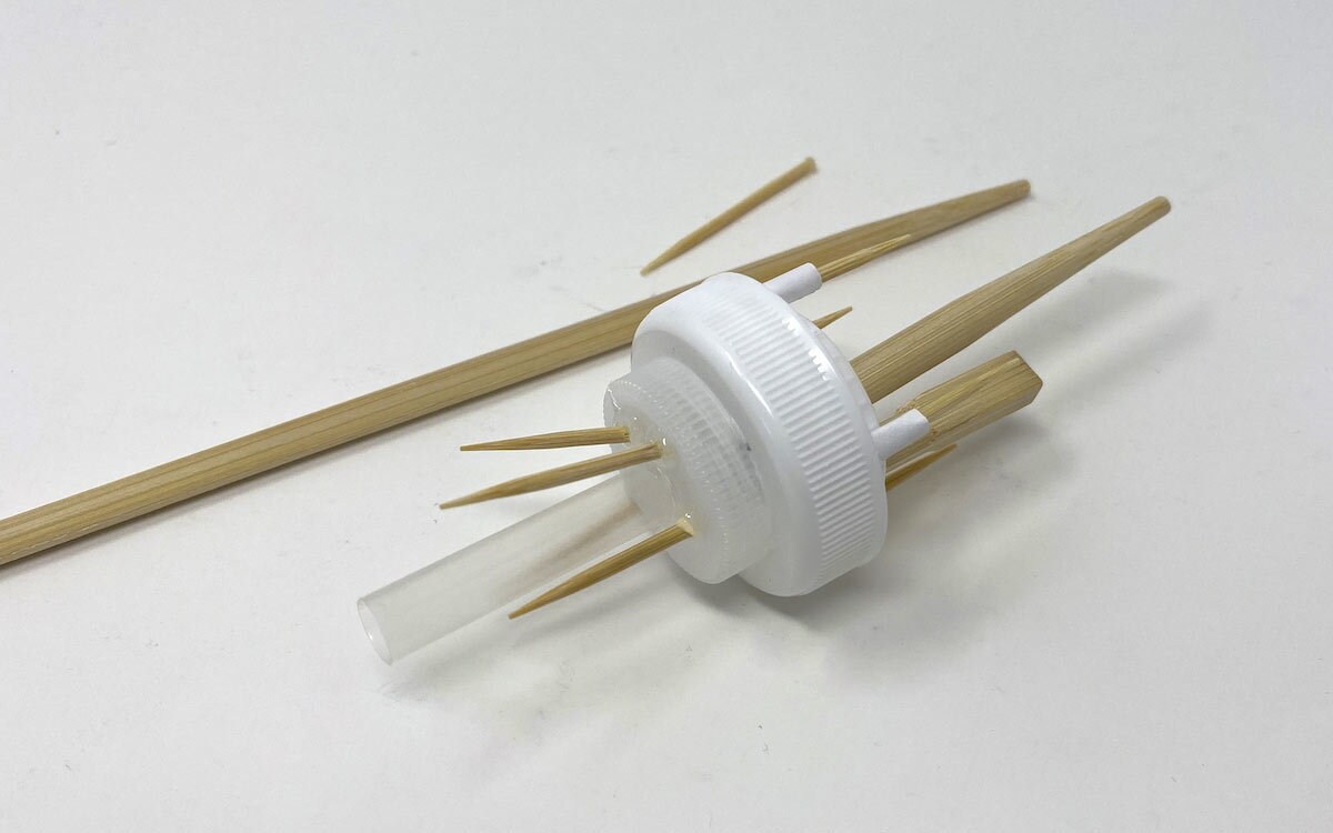 Two toothpicks and glue the four pieces around the straw, pointed side up