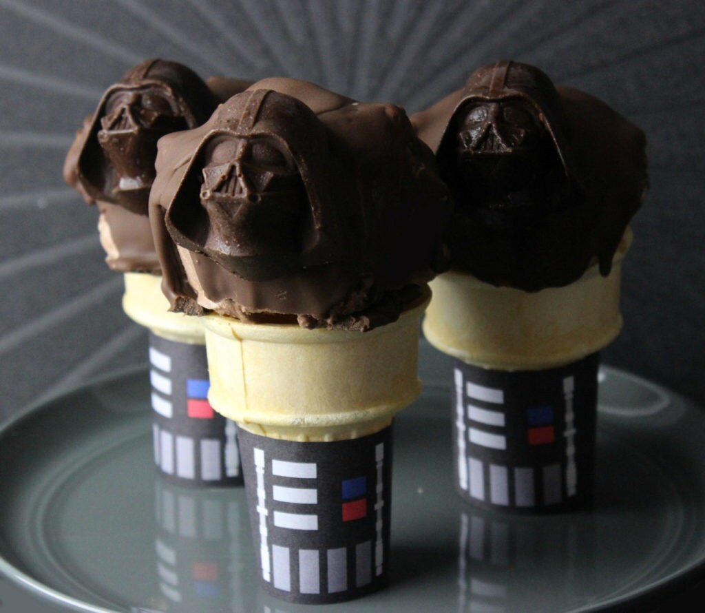A tray of Darth Chocolate Cones. The ice cream cones are decorated to look like Darth Vader's body and the ice cream on top is in a chocolate shell molded in the shape of Darth Vader's helmet.