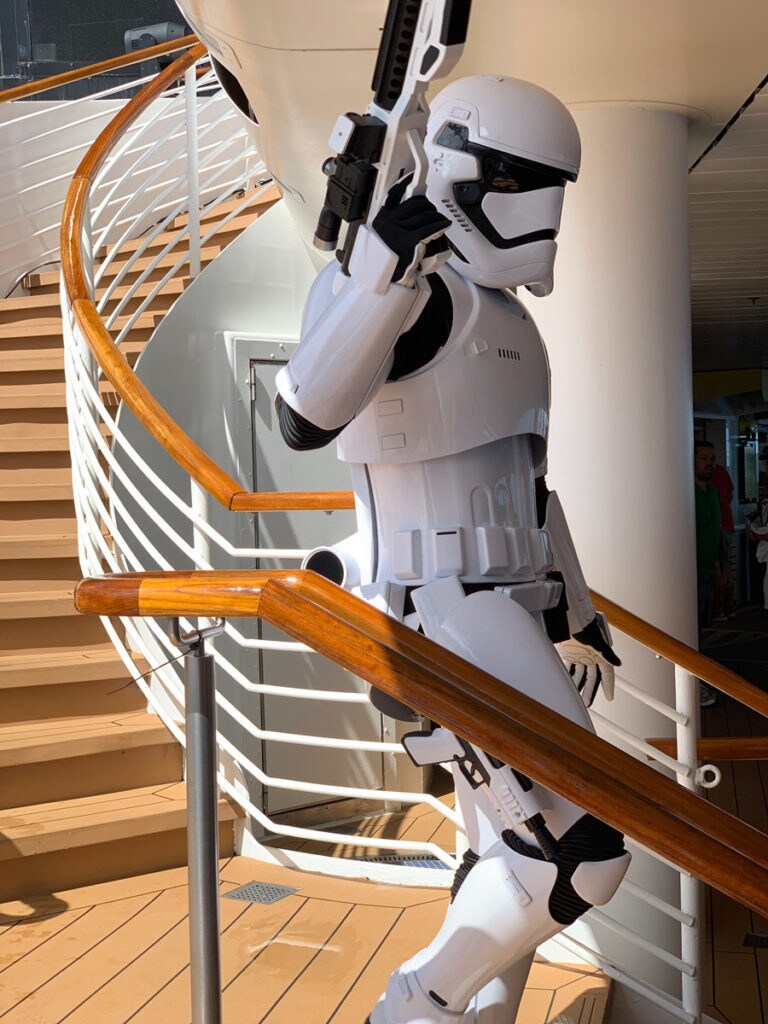 A stormtrooper walks the pool area on Star Wars Day at Sea.