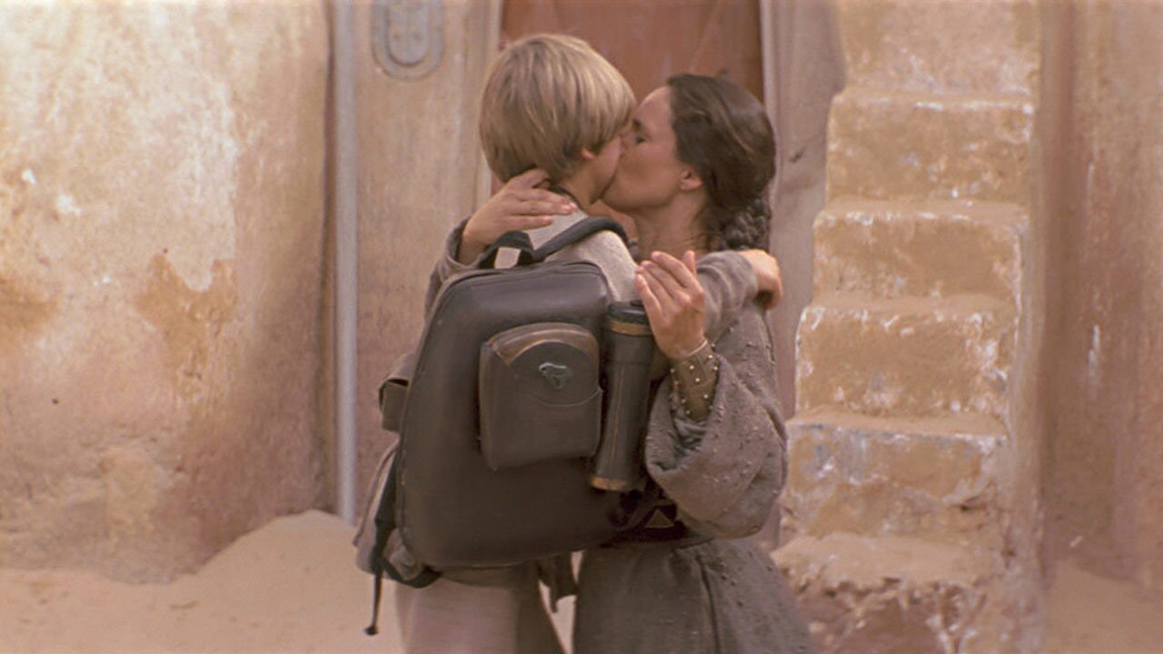 Shmi kisses Anakin goodbye before Anakin leaves home.