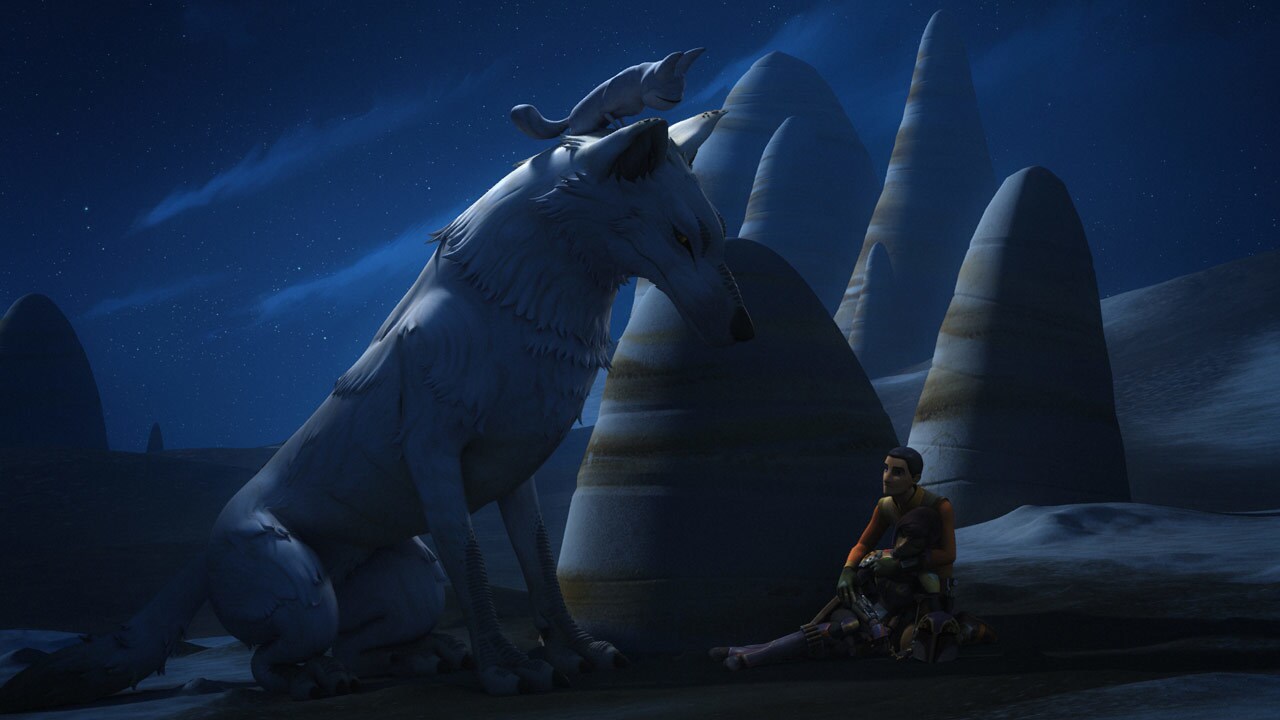 Ezra Bridger crouches in front of a huge Loth-wolf, which has a Loth-cat perched on its head, in the dark of night in Star Wars Rebels.