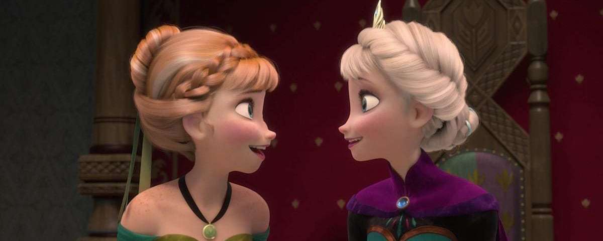 Anna and Elsa from Frozen smile at each other.