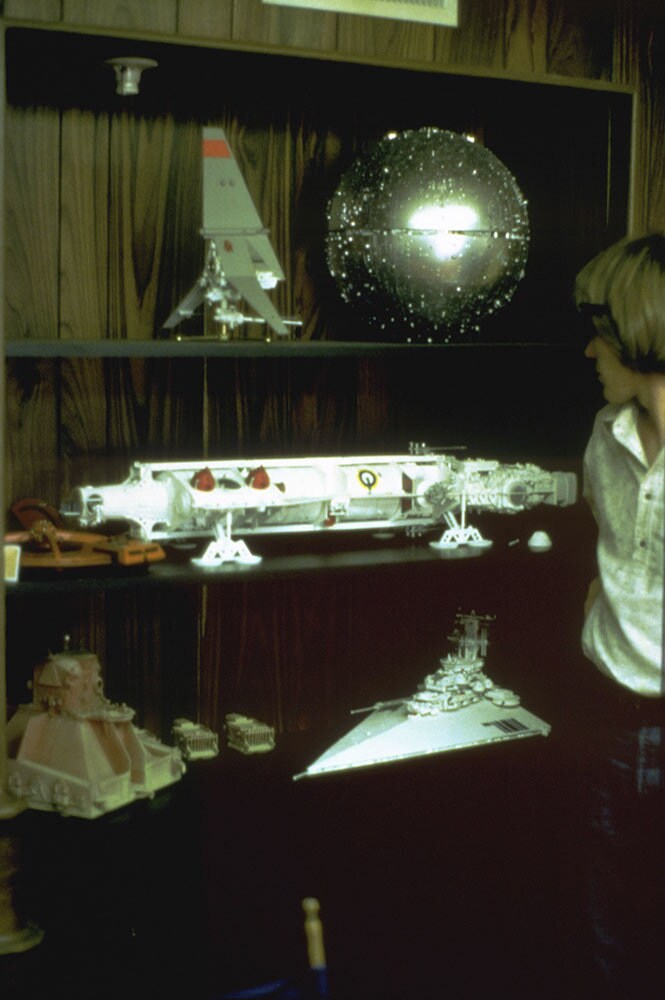 A shelf filled with Colin Cantwell's ship models