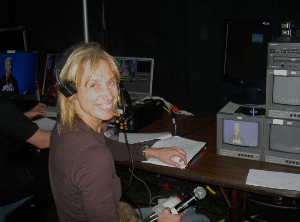 Mary Franklin, producer of Star Wars Celebration, sits before a series of small monitors.