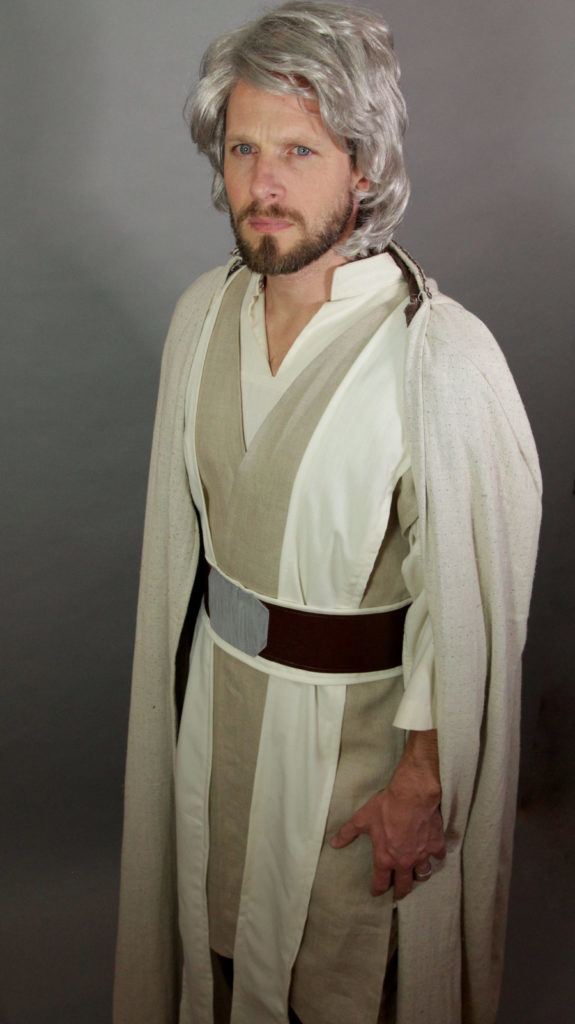 A person in a gray wig models a DIY Luke Skywalker Halloween costume.