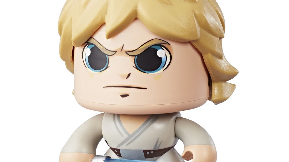 A Luke Skywalker Star Wars Mighty Muggs collectible figure holds a lightsaber with a stern expression on its face.