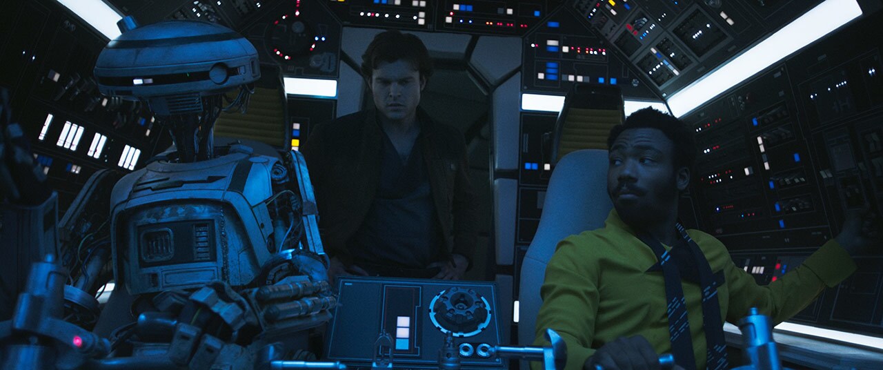 Han, Lando, and L3-37 in the Millennium Falcon cockpit in Solo: A Star Wars Story.