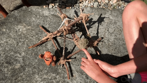 A GIF shows a child launching a homemade Ewok catapult while a Wicket figurine stands in front of it.
