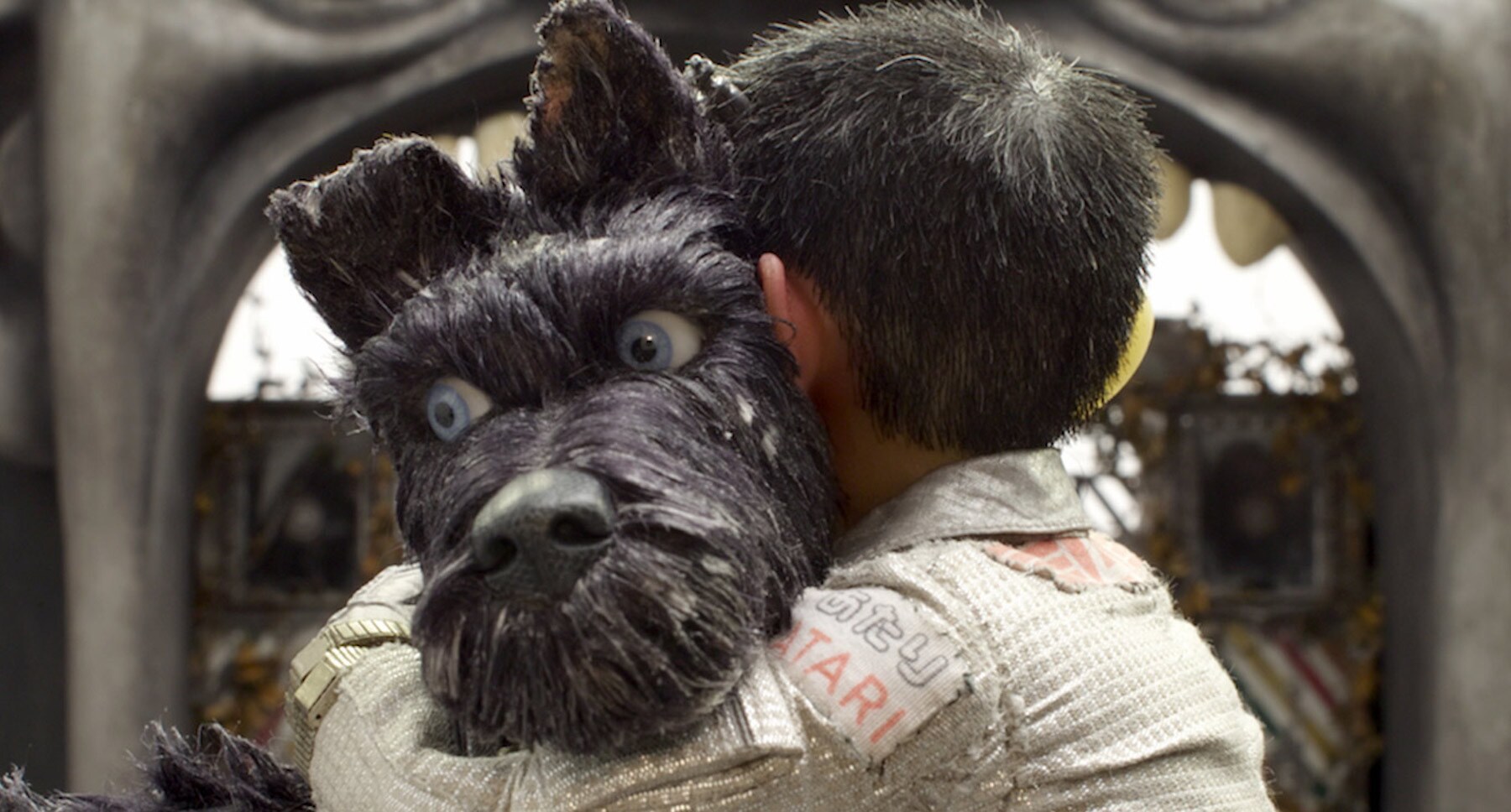Bryan Cranston (as Chief) and Koyu Rankin (Atari) in a hug in "Isle of Dogs"