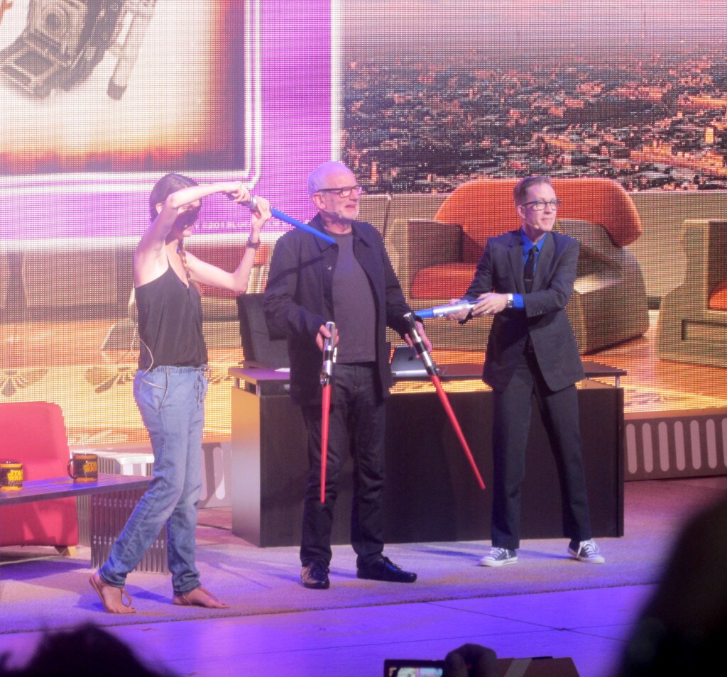 Celebrities play with toy lightsabers during the Stars of the Saga talk show.