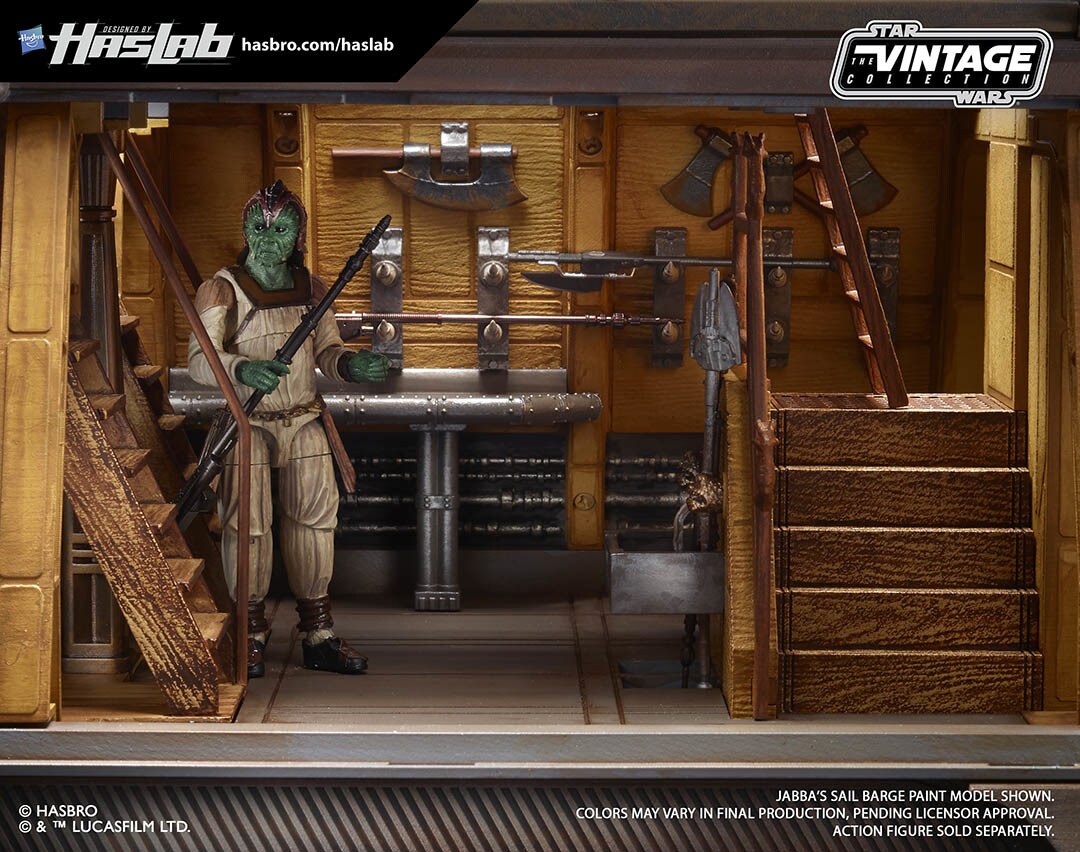 A Klaatu action figure stands inside the armory room of a Jabba's Sail Barge model vehicle.