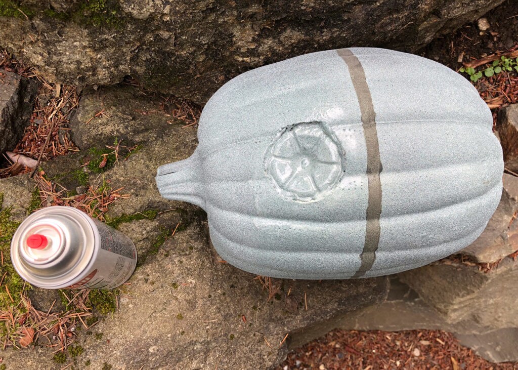 A painted pumpkin made to look like the Death Star, and a canister of spray paint.