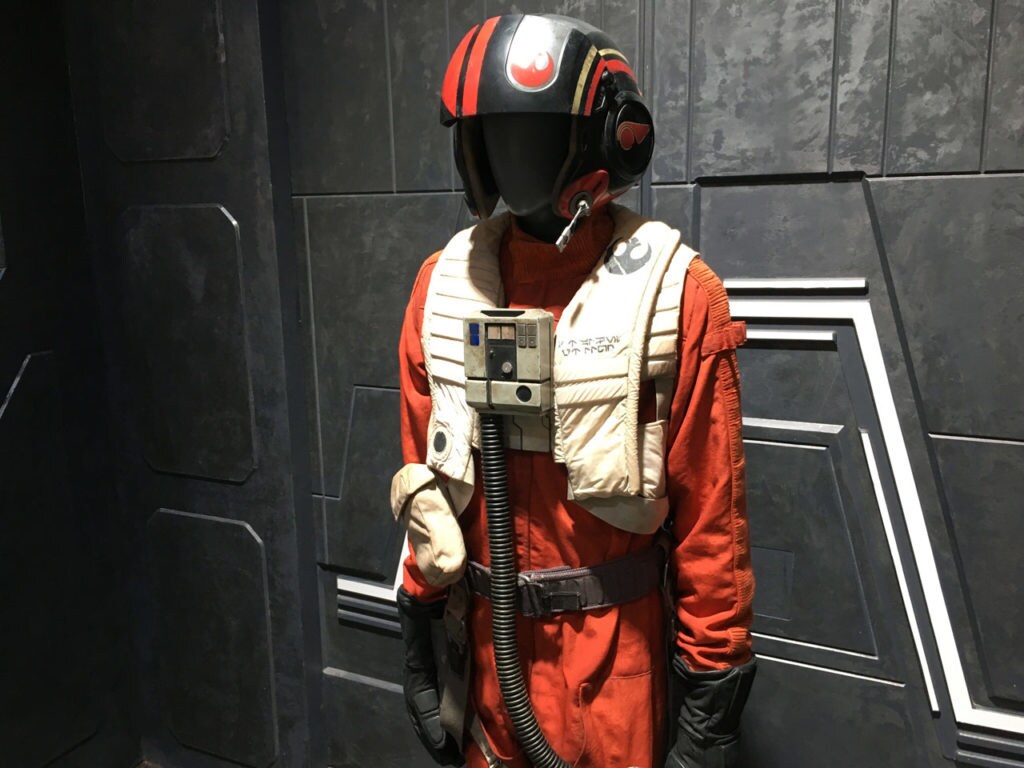 A Resistance pilot uniform on display at the NYCC 2017 Star Wars: The Last Jedi Prop Gallery.
