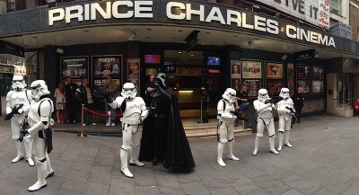 Darth Vader and a group of Stormtroopers stand outside Prince Charles Cinema.