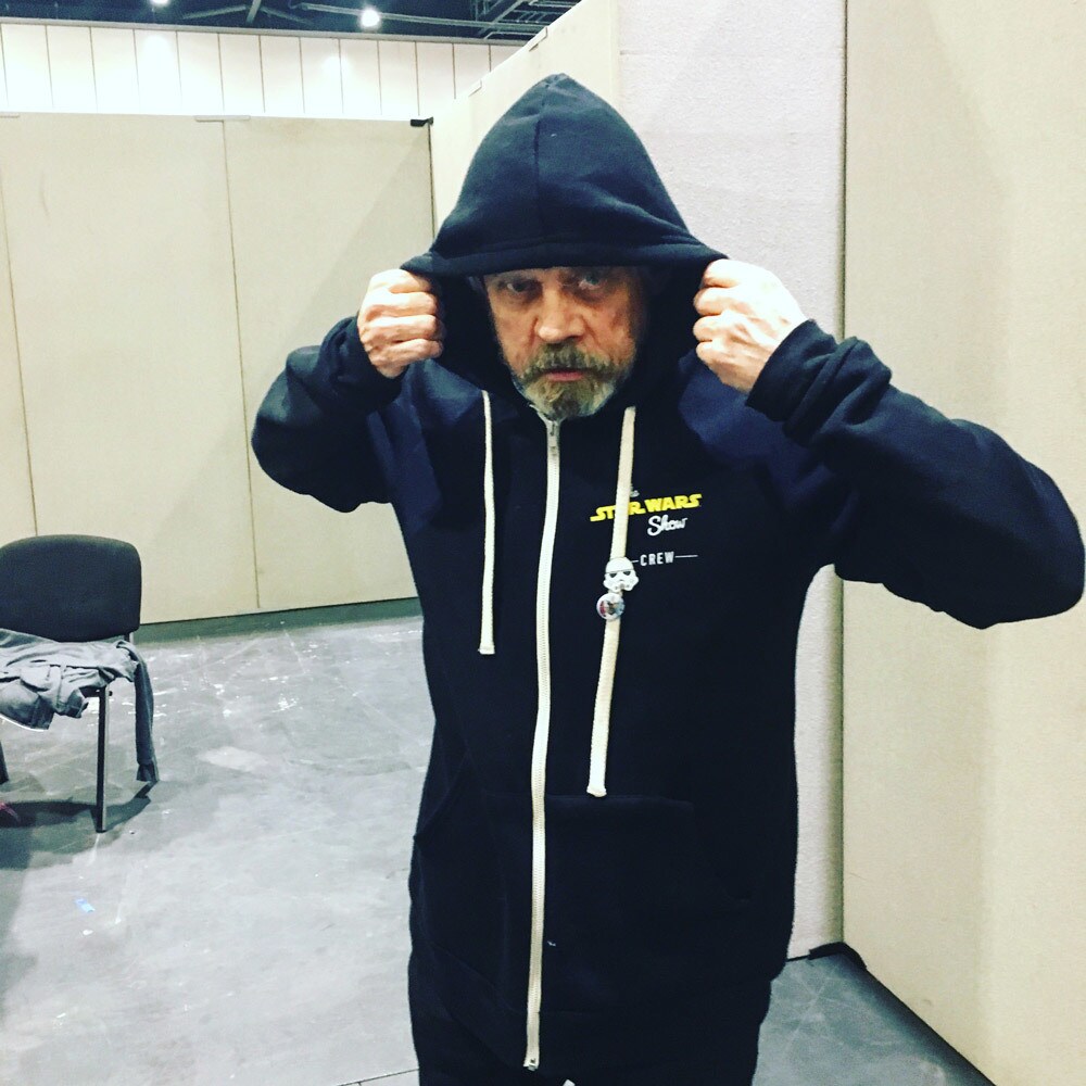 Mark Hamill in disguise in a Star Wars Show hoodie at Star Wars Celerbration.