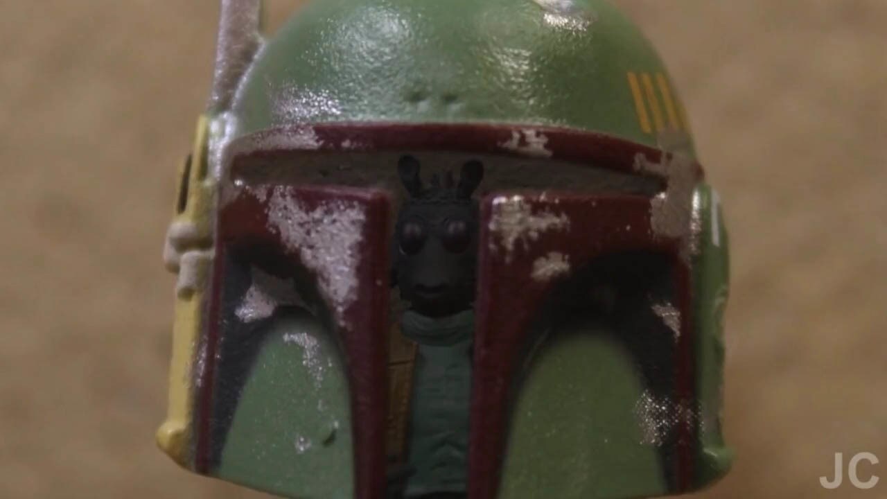 Greedo is reflected in Boba Fett's helmet in a scene from "Bounty Buddies."