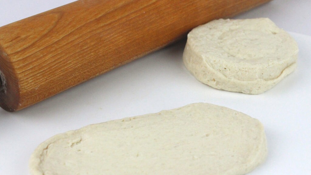A rolling pin and dough.