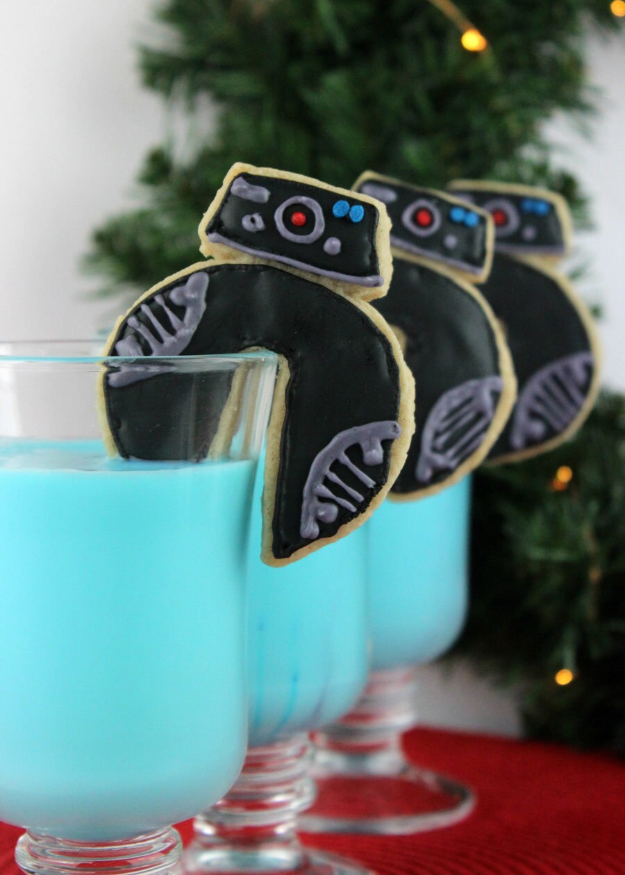 BB-9E cookies garnish three glasses of blue milk.